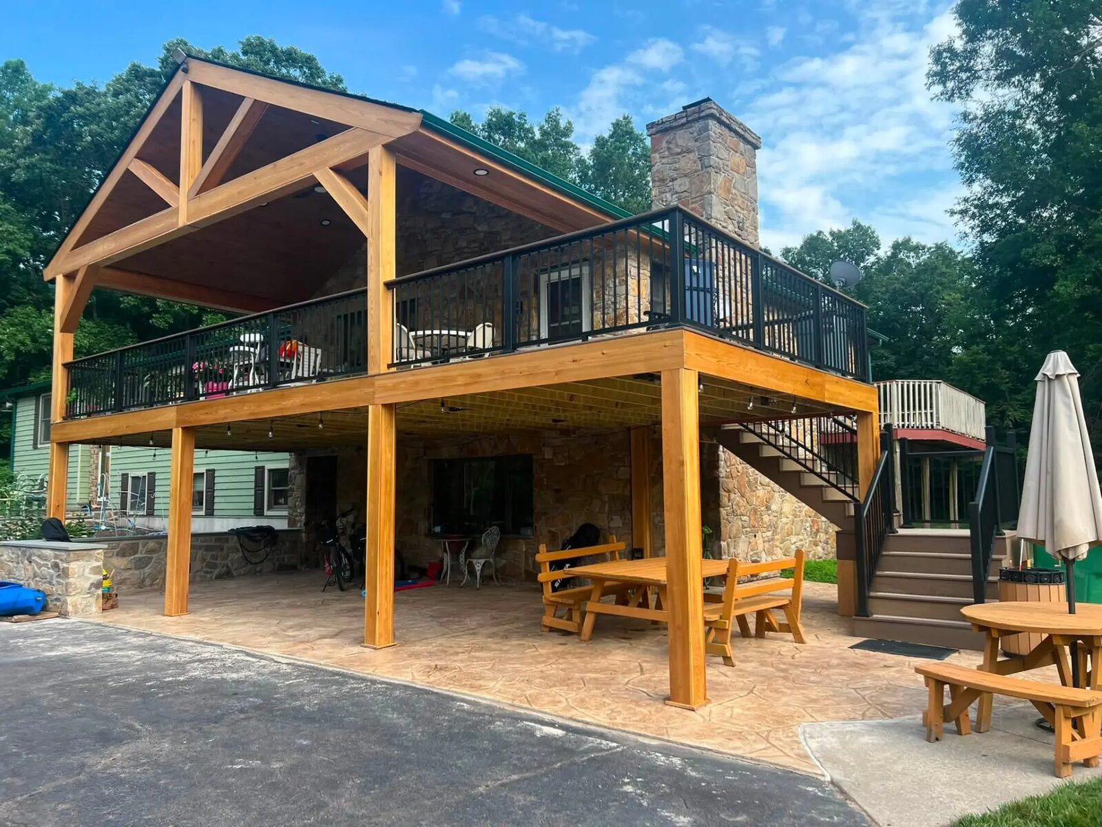Timber-framed covered deck and stamped concrete patio built by D. Becker Contracting